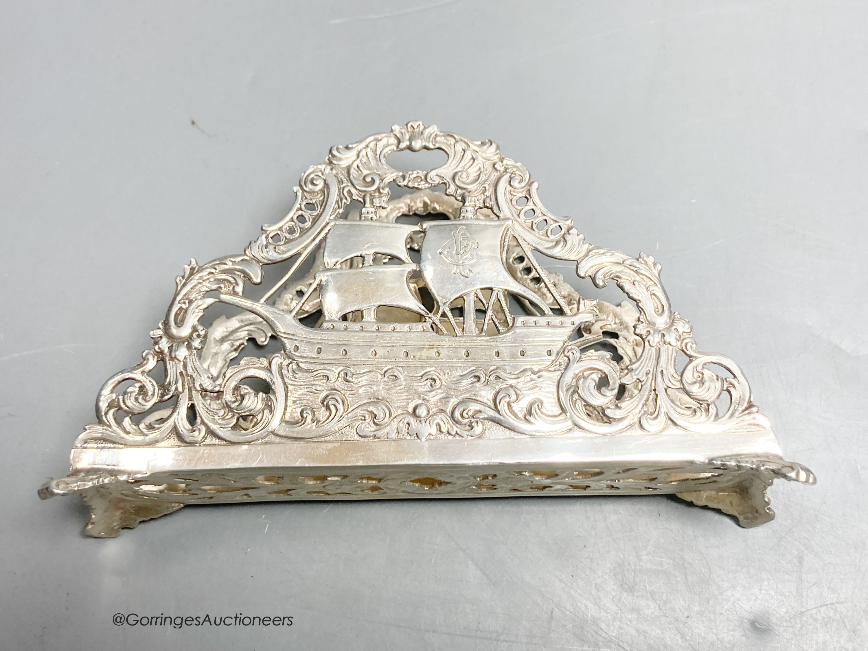 Two early 20th century German 800 standard pierced white metal letter racks, decorated with sailing ships, longest 13.8cm